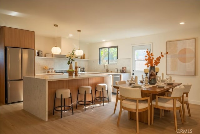 23919 Friar St, Woodland Hills, CA 91367 - kitchen with appliances with stainless steel finishes, decorative backsplash, open shelves, light wood-style floors, and recessed lighting