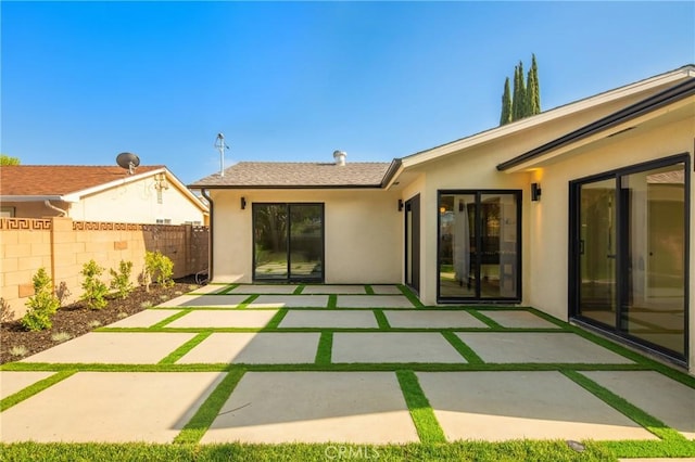 23919 Friar St, Woodland Hills, CA 91367 - rear view of property featuring stucco siding, fence, and a patio