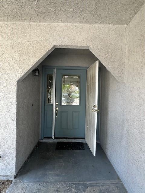 doorway to property with stucco siding