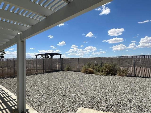 view of yard with a fenced backyard and a pergola