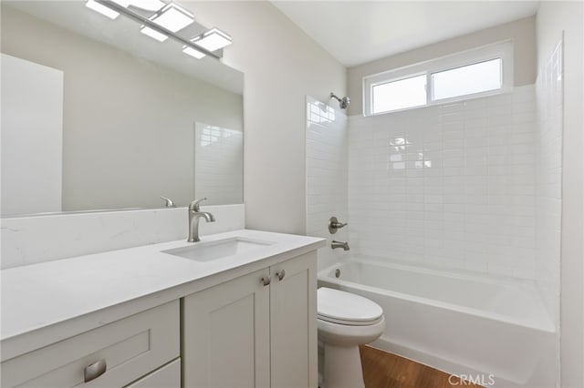 bathroom with vanity, shower / tub combination, wood finished floors, and toilet