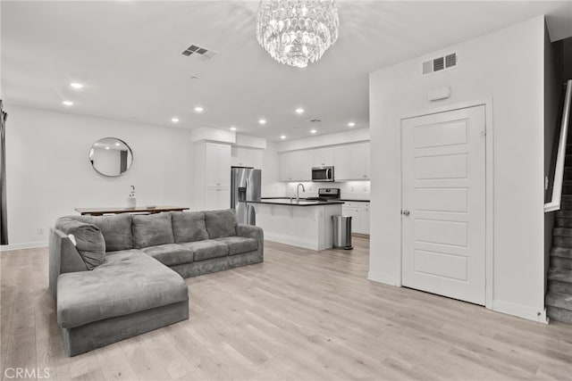12814 Watt Ln Unit B, Sylmar, CA 91342 - living area featuring light wood-style floors, recessed lighting, a chandelier, and visible vents