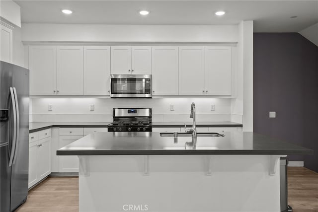 12814 Watt Ln Unit B, Sylmar, CA 91342 - kitchen with white cabinets, stainless steel appliances, a sink, and light wood-style floors
