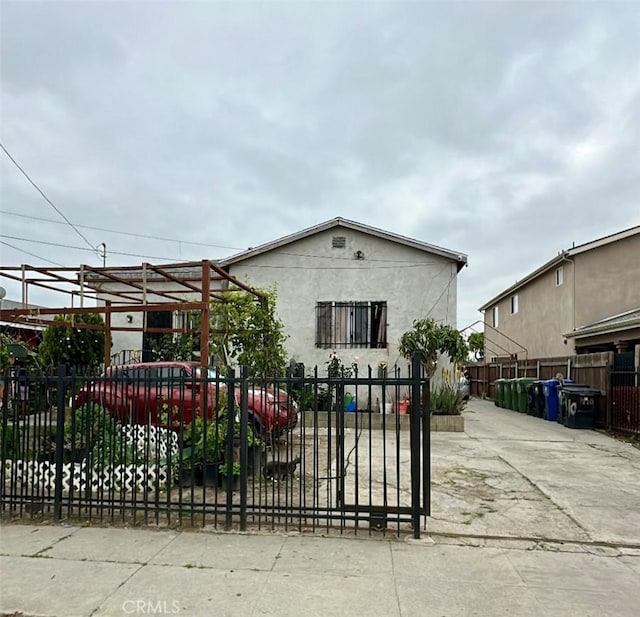 1410 E 110th St, Los Angeles, CA 90059 - view of front facade with stucco siding and fence private yard