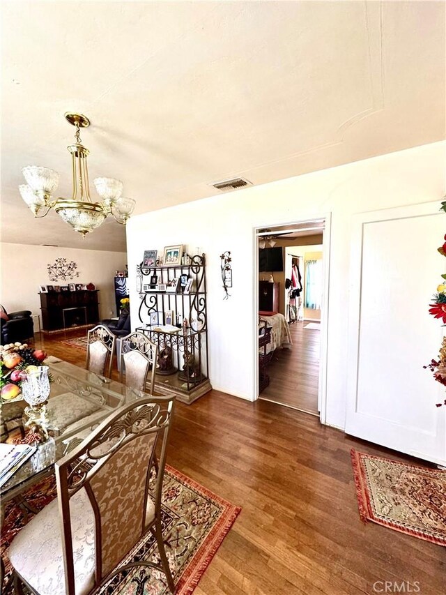 5214 Golden Ave, Riverside, CA 92505 - dining area featuring visible vents, wood finished floors, and a notable chandelier