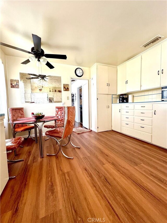 5214 Golden Ave, Riverside, CA 92505 - dining area with ceiling fan, wood finished floors, and visible vents