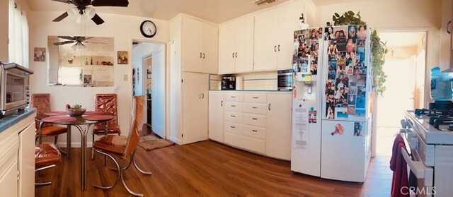 5214 Golden Ave, Riverside, CA 92505 - kitchen with a ceiling fan, white appliances, wood finished floors, and white cabinetry