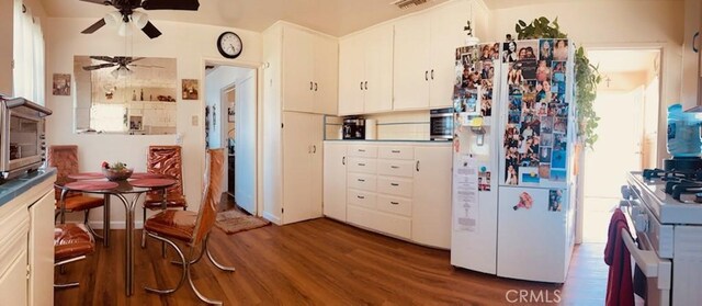 5214 Golden Ave, Riverside, CA 92505 - kitchen with ceiling fan, white appliances, wood finished floors, and white cabinetry