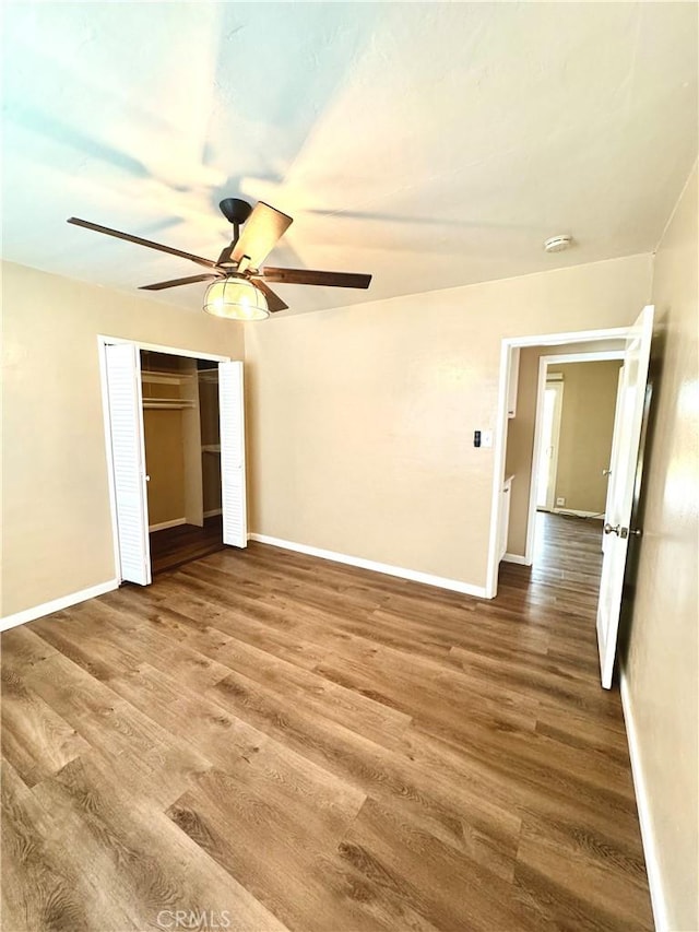 5214 Golden Ave, Riverside, CA 92505 - unfurnished bedroom with baseboards, a ceiling fan, wood finished floors, and a closet