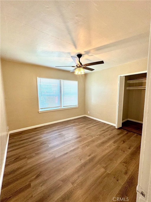 5214 Golden Ave, Riverside, CA 92505 - unfurnished bedroom featuring a ceiling fan, baseboards, wood finished floors, and a closet
