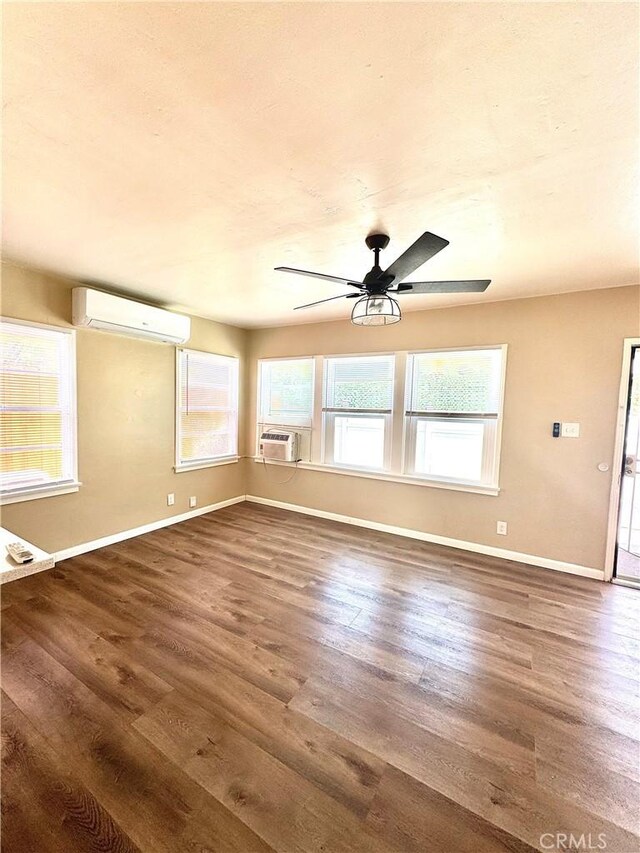 5214 Golden Ave, Riverside, CA 92505 - interior space featuring baseboards, a wall mounted air conditioner, and wood finished floors