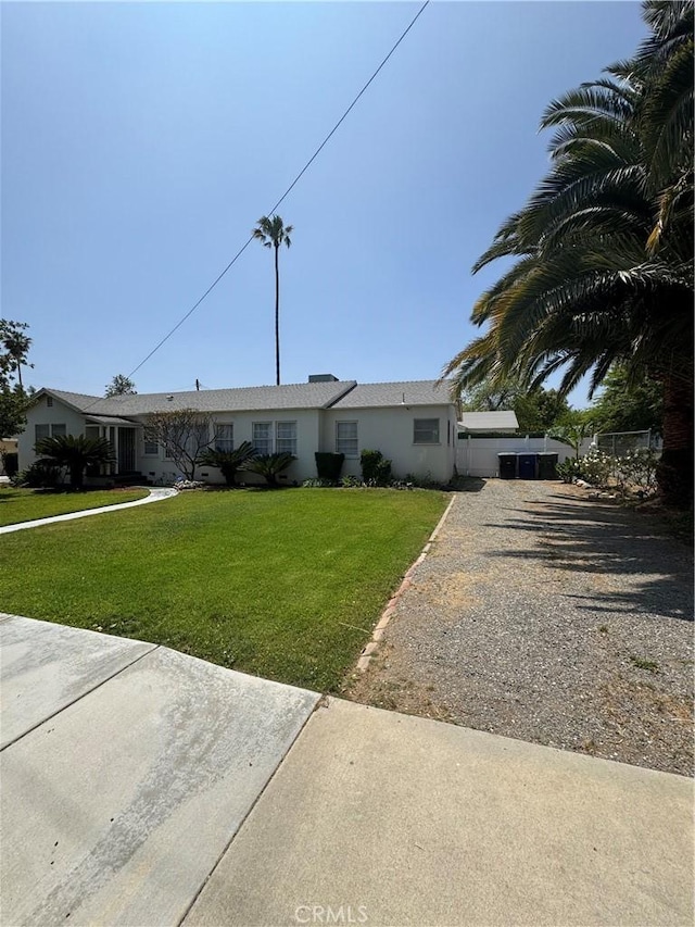 5214 Golden Ave, Riverside, CA 92505 - ranch-style house featuring stucco siding, driveway, and a front yard