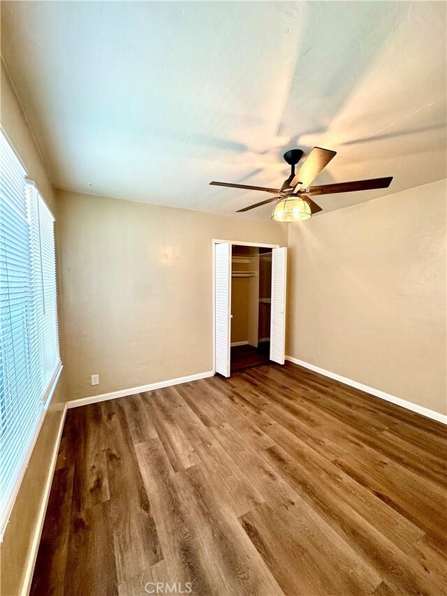 5214 Golden Ave, Riverside, CA 92505 - unfurnished bedroom featuring baseboards, a ceiling fan, wood finished floors, and a closet