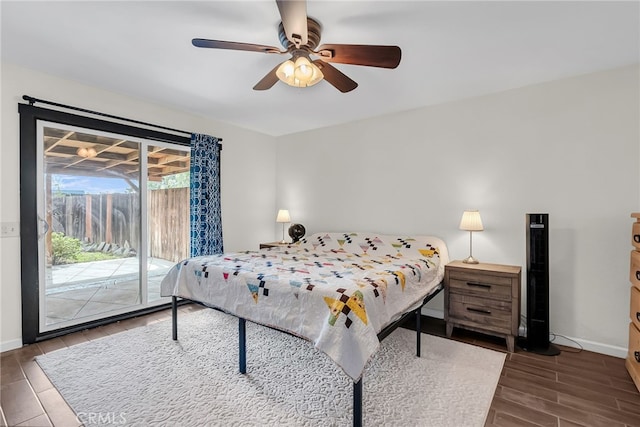 bedroom featuring baseboards, a ceiling fan, wood finish floors, and access to exterior