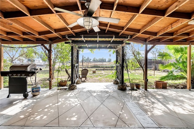 view of patio featuring a ceiling fan, fence, and grilling area