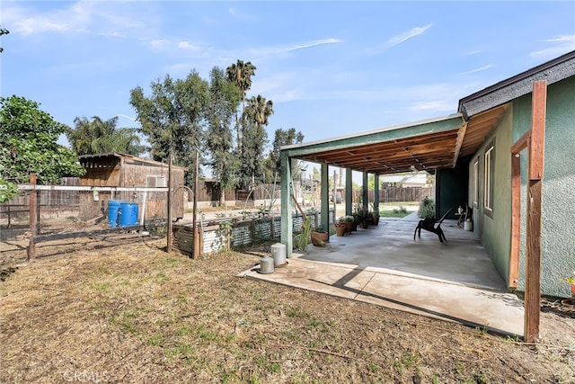 view of yard featuring a fenced backyard, a garden, and a patio area