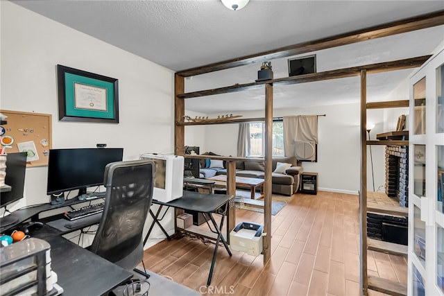 office area with a textured ceiling and wood finished floors