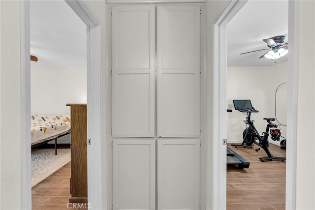 hallway with baseboards and wood finished floors