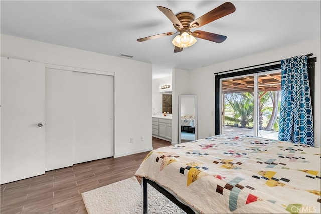 bedroom featuring visible vents, wood finished floors, access to outside, connected bathroom, and a ceiling fan