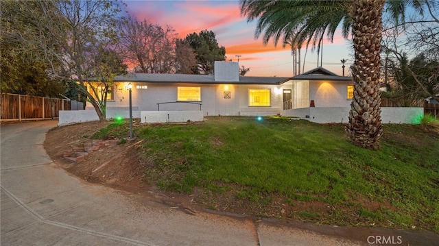 5092 Myrtle Ave, Riverside, CA 92506 - ranch-style home with stucco siding, a front lawn, fence, and a chimney