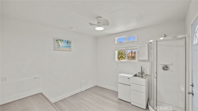 5092 Myrtle Ave, Riverside, CA 92506 - full bathroom with baseboards, wood finished floors, a shower stall, and a sink