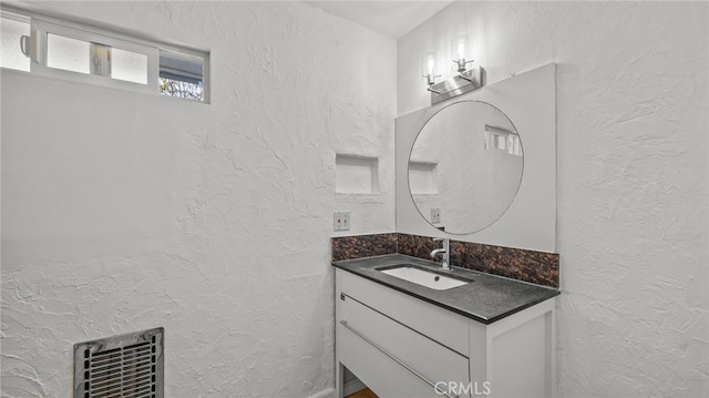 5092 Myrtle Ave, Riverside, CA 92506 - bathroom with a textured wall, visible vents, and vanity