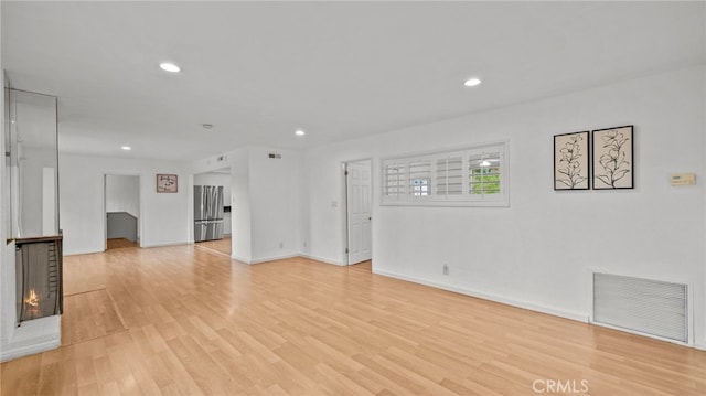 5092 Myrtle Ave, Riverside, CA 92506 - unfurnished living room with light wood-style floors, a fireplace, recessed lighting, and visible vents