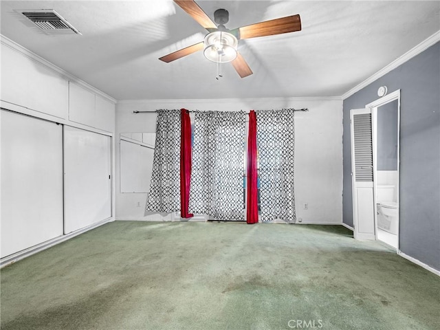 449 Highland Ave, Barstow, CA 92311 - unfurnished bedroom with crown molding, carpet floors, a closet, and visible vents
