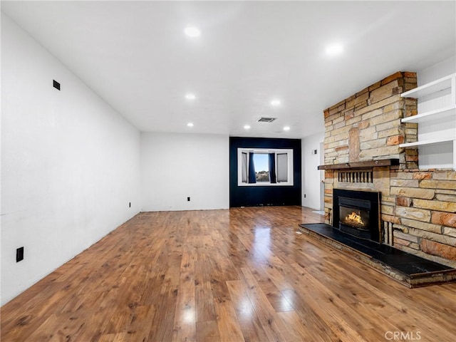 449 Highland Ave, Barstow, CA 92311 - unfurnished living room with hardwood / wood-style flooring, a fireplace, recessed lighting, and visible vents