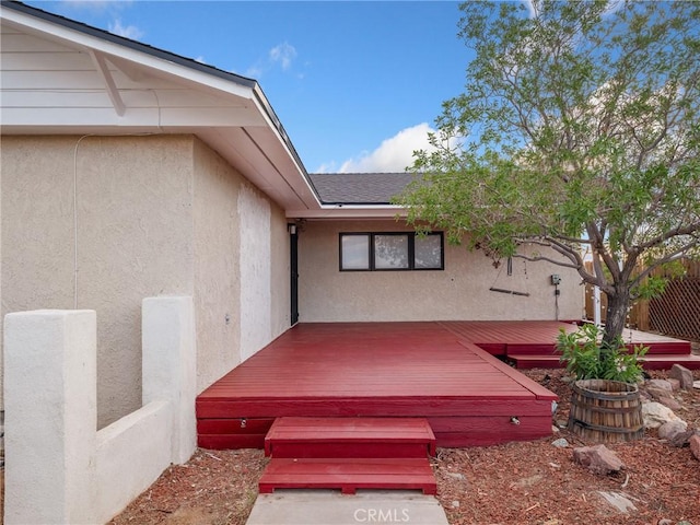 449 Highland Ave, Barstow, CA 92311 - view of exterior entry with a deck, fence, and stucco siding