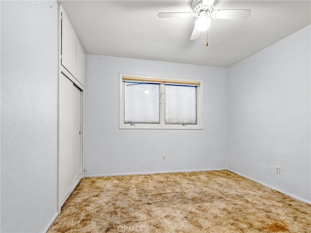 449 Highland Ave, Barstow, CA 92311 - unfurnished bedroom featuring baseboards, a ceiling fan, carpet, and a closet