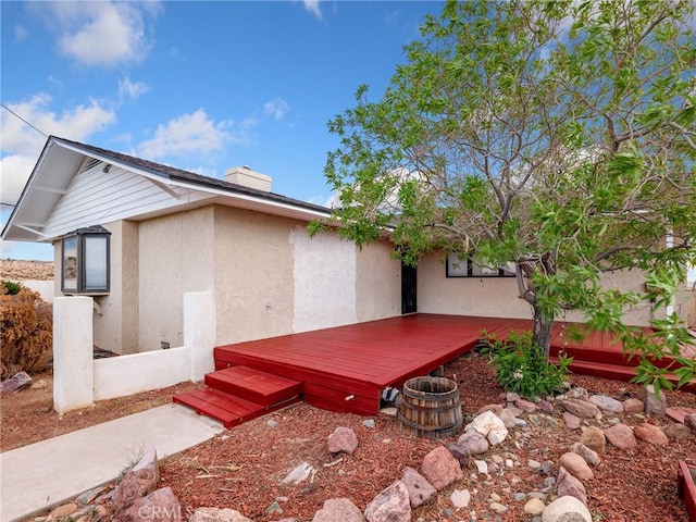 449 Highland Ave, Barstow, CA 92311 - rear view of property featuring a deck, a chimney, and stucco siding