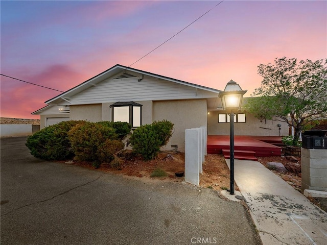 449 Highland Ave, Barstow, CA 92311 - view of front facade featuring a garage and stucco siding