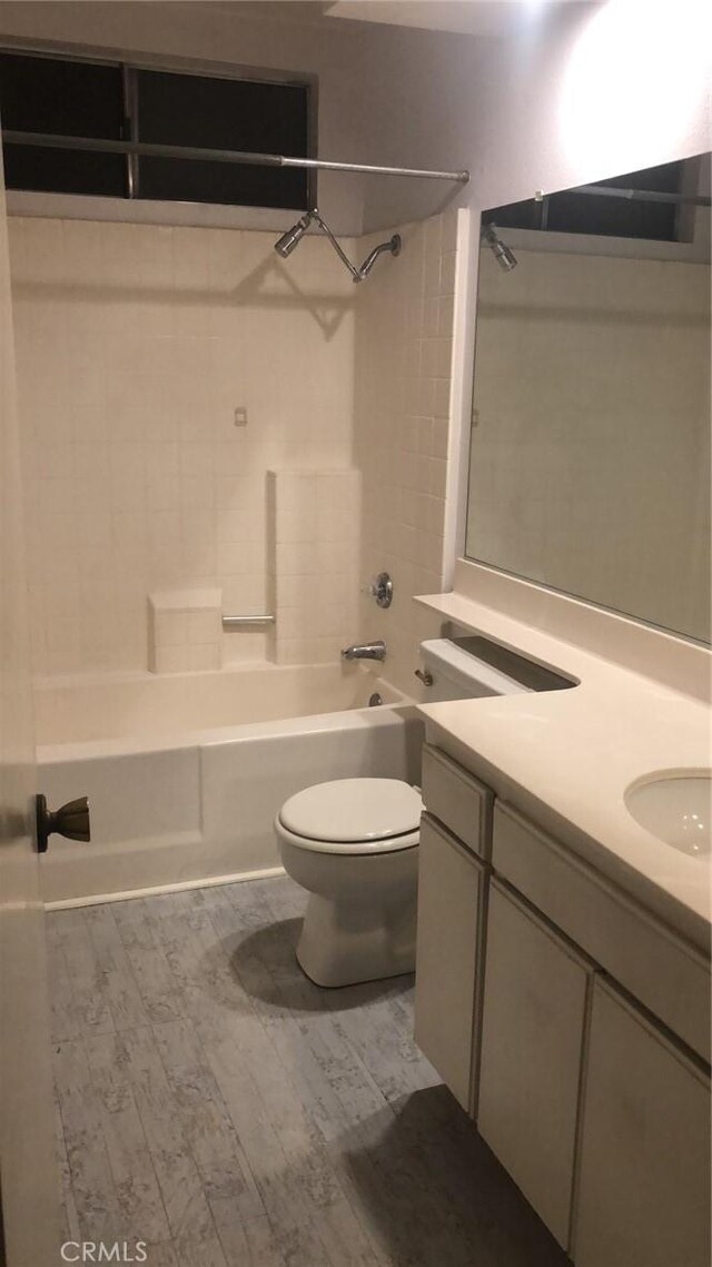 6483 N Walnut Ave, San Bernardino, CA 92407 - full bath featuring wood finished floors, toilet, vanity, and bathing tub / shower combination