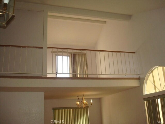 6483 N Walnut Ave, San Bernardino, CA 92407 - empty room with a chandelier and beamed ceiling
