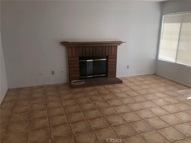 6483 N Walnut Ave, San Bernardino, CA 92407 - unfurnished living room featuring a fireplace and light tile patterned floors