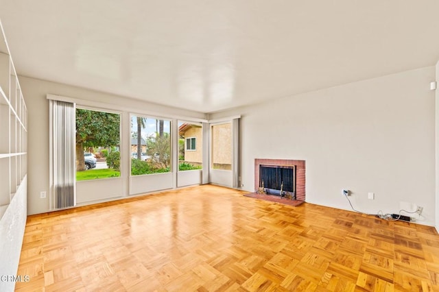 unfurnished living room with a brick fireplace
