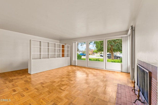 unfurnished living room featuring a fireplace with flush hearth