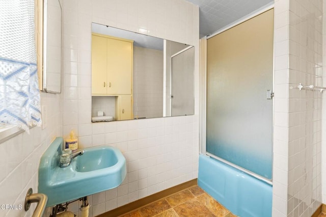full bathroom featuring a sink and a shower with shower door