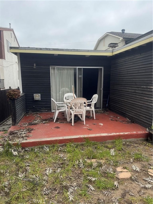 back of property featuring a wooden deck