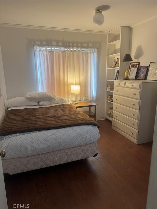 bedroom featuring dark wood-style flooring and ornamental molding