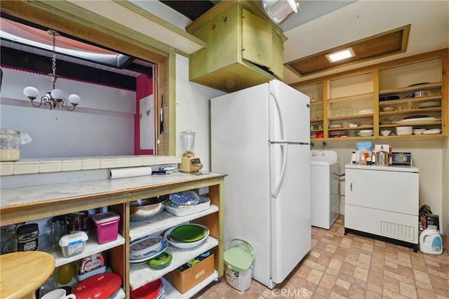 2218 Pacific Ave, Venice, CA 90291 - kitchen with freestanding refrigerator, light countertops, a chandelier, and brick patterned flooring