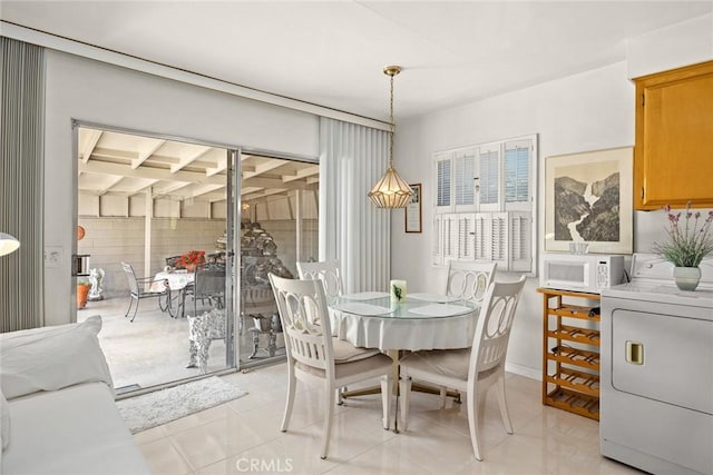 dining room with washer / dryer and light tile patterned floors