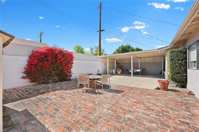 view of patio / terrace with outdoor dining area and fence