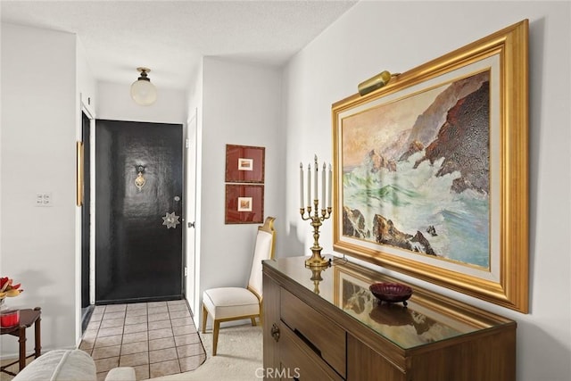 entryway featuring baseboards and light tile patterned floors
