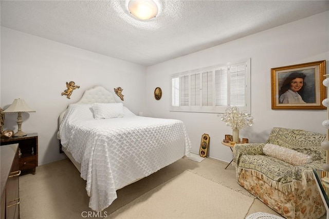 carpeted bedroom featuring a textured ceiling