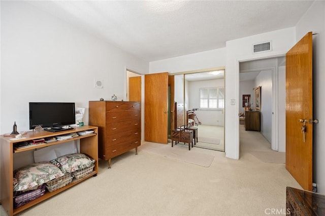 home office with visible vents and light carpet
