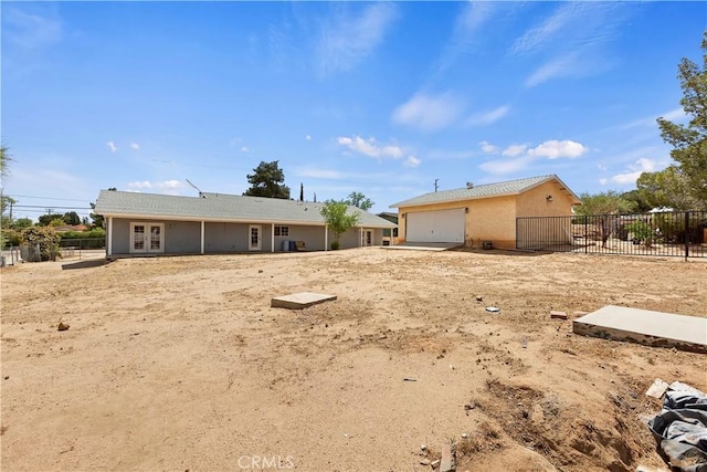 18060 Walnut St, Hesperia, CA 92345 - rear view of property with french doors, a garage, and stucco siding