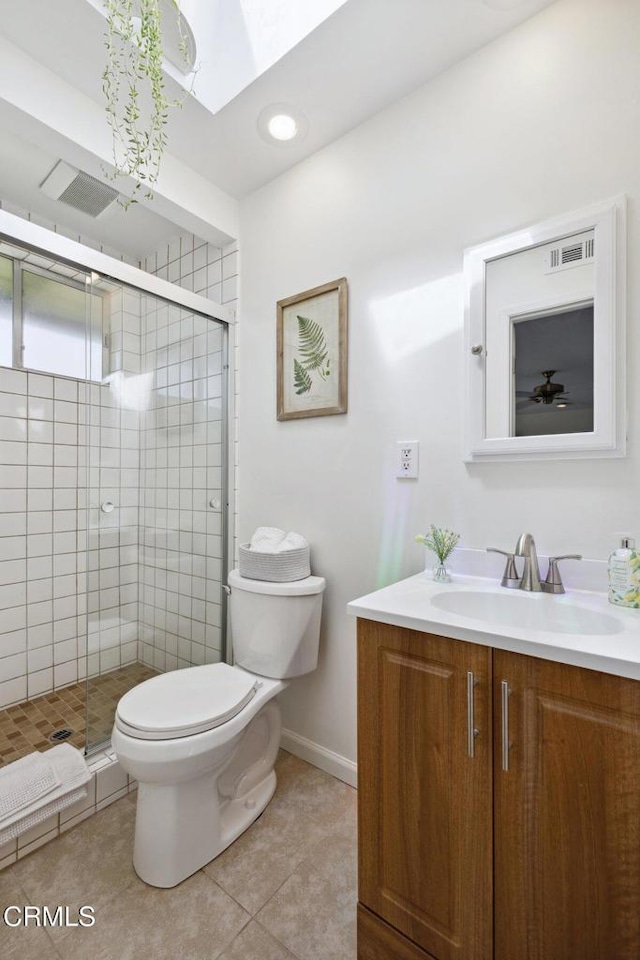 921 Topaz Ct, Ojai, CA 93023 - full bath with a skylight, a shower stall, vanity, tile patterned floors, and toilet