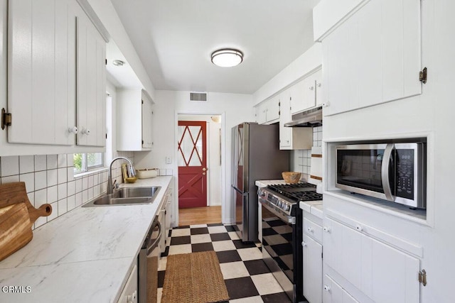 921 Topaz Ct, Ojai, CA 93023 - kitchen featuring visible vents, appliances with stainless steel finishes, a sink, dark floors, and under cabinet range hood